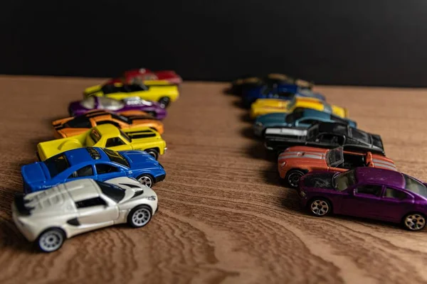 Selective focus shot of toy sports car in a line on a wooden surface — Stock Photo, Image