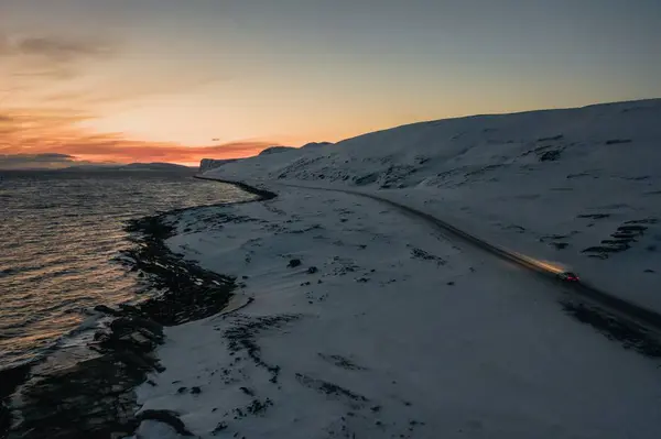 Pôr do sol sobre a paisagem montanhosa no lago em Nordkapp, Noruega — Fotografia de Stock