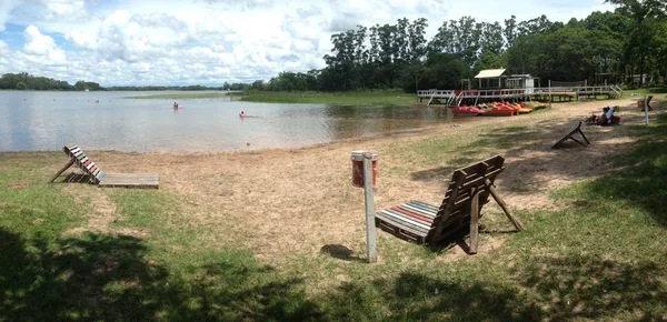 Playa Laguna beach surrounded by the lake and greenery under a cloudy sky in Argentina — Stok fotoğraf