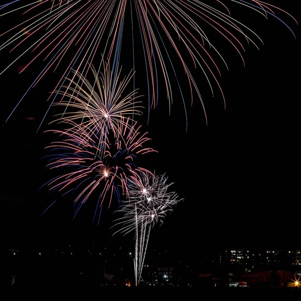 Beautiful shot of colorful fireworks in the night sky during holidays — Stock Photo, Image