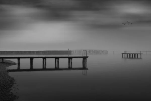 Greyscale Shot Wooden Pier Sea Beautiful Cloudy Sky — Stock Photo, Image