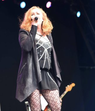 BRISTOL, ENGLAND, UNITED KINGDOM - Jun 03, 2017: Carol Decker in performance at the Let's Rock Retro music festival, Ashton Court, Bristol, England. 3 June 2017. clipart