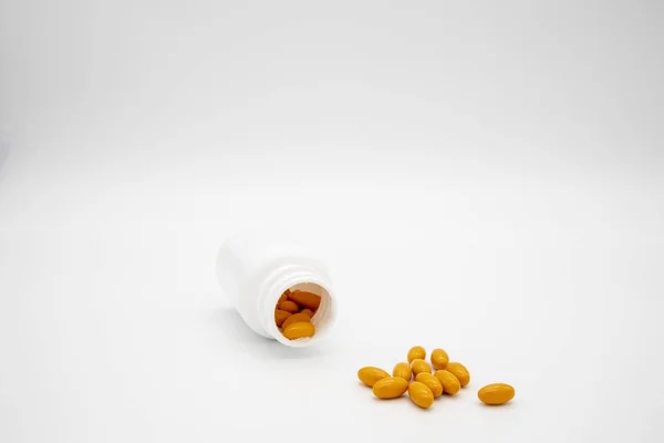 Orange Pills Spilling Out White Pill Bottle White Background — 스톡 사진