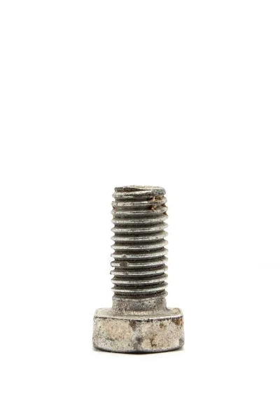 Closeup of a rusty bolt under the lights against a white background — Stock Photo, Image