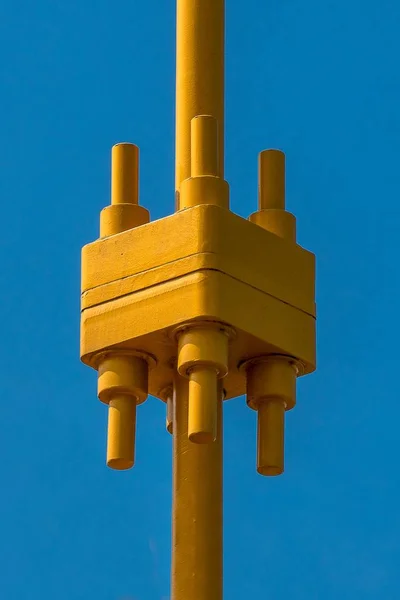 Vertical Shot Brightly Colored Yellow Metal Contraption Pure Blue Background — 스톡 사진