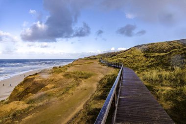 Wooden road on the Red Cliff near the beach in Sylt, Germany clipart
