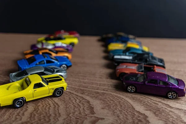 Selective focus shot of toy sports car in a line on a wooden surface — Stock Photo, Image