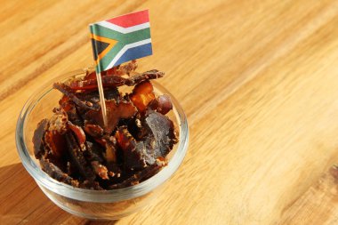 Flag of South America on traditional biltong snack on a wooden surface clipart