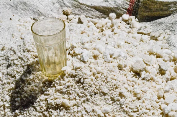 Glass cup on a surface covered with salt — Stock Photo, Image
