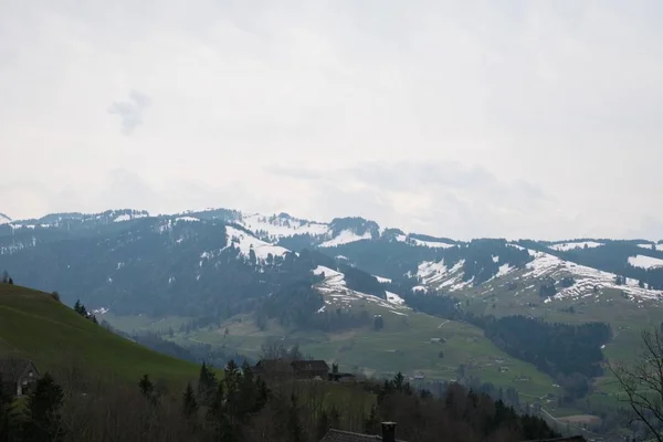 Aerial Shot Beautiful Mountain Range Covered Snow Cloudy Sky — Stok fotoğraf