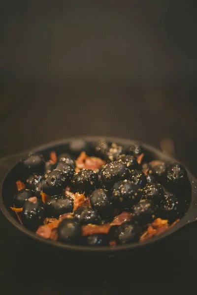 Vertical shot of a side dish with black olives in a small bowl — Stok fotoğraf