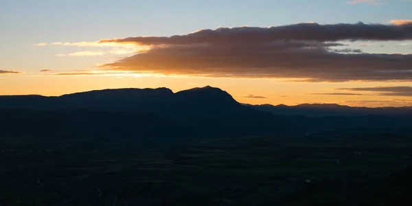 背景に夕日が沈む丘のある緑豊かな風景 — ストック写真