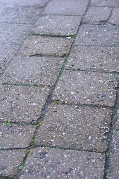 Vertical high angle shot of the cobblestone ground of the street — Stock Photo, Image