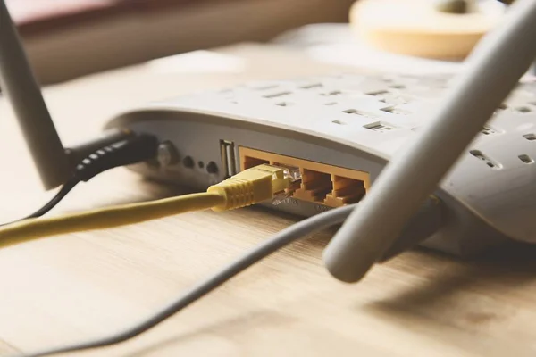 Selective Focus Shot Internet Modem Yellow Cable Wooden Surface — 스톡 사진