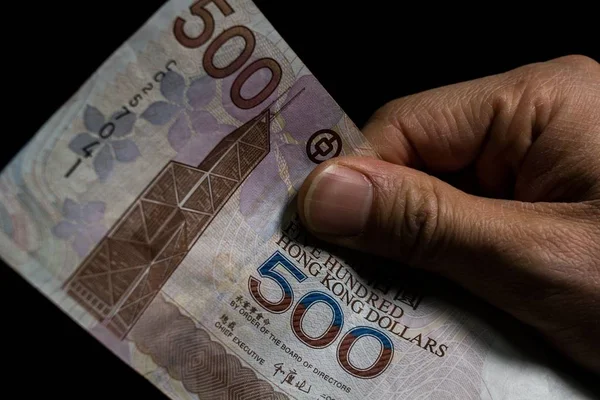 Closeup shot of 500 Hong Kong dollars (HKD) banknotes in front of a black background — Stock Photo, Image