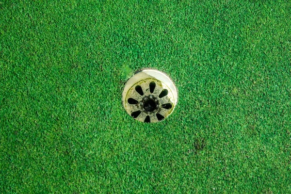 スロベニアのオクトセックのゴルフ場の緑の芝生に囲まれた穴を高角度で撃った — ストック写真