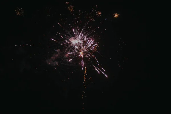 Low angle shot of festive fireworks bursting in the night sky spreading a joyful atmosphere — Stock Photo, Image