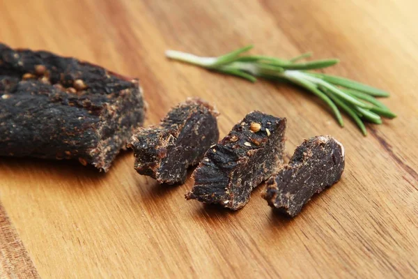 Sliced Stick Biltong Snack Rosemary Seasoning Wooden Surface — Stock Photo, Image