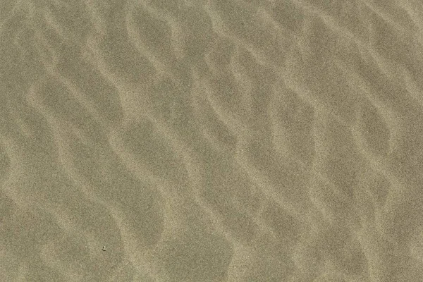 Nahaufnahme von Sand am Strand im Sonnenlicht - ein schönes Bild für Tapeten und Hintergründe — Stockfoto