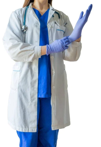 Female doctor in a medical uniform and mask putting on medical gloves getting ready for a surgery — Stock Photo, Image