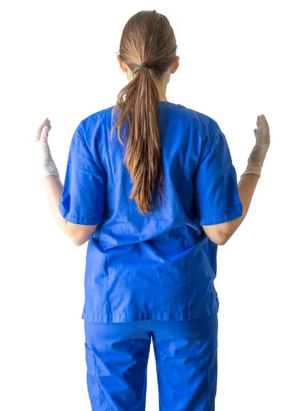 Mavi üniformalı, sterilize eldiven giyen, beyaz arka planda izole edilmiş bir kadın doktor. — Stok fotoğraf