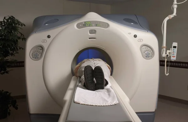 Person lying in an MRI scanner under the lights in a hospital — Stock Photo, Image