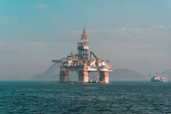 Oil extraction platform in the sea surrounded by hills in Rio De Janeiro in Brazil