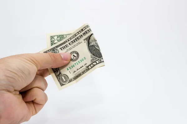 Κοντινό πλάνο ενός ατόμου που κρατάει ένα δολάριο πάνω από ένα λευκό φόντο — Φωτογραφία Αρχείου