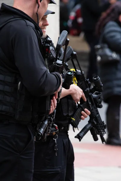 Close up of 2 armed police officers stood in the crowds of leeds — 스톡 사진