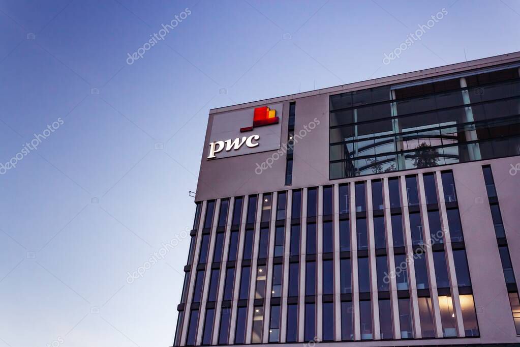 MUNICH, GERMANY - Jun 25, 2019: PwC tax office building in munich entry logo sign blue sky empty space