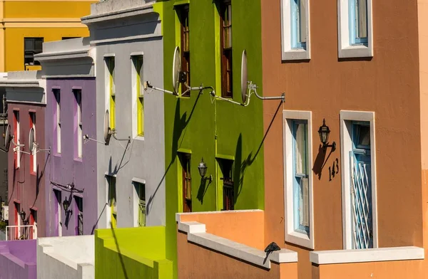 Edifícios multicoloridos de uma cidade construída ao lado uns dos outros — Fotografia de Stock