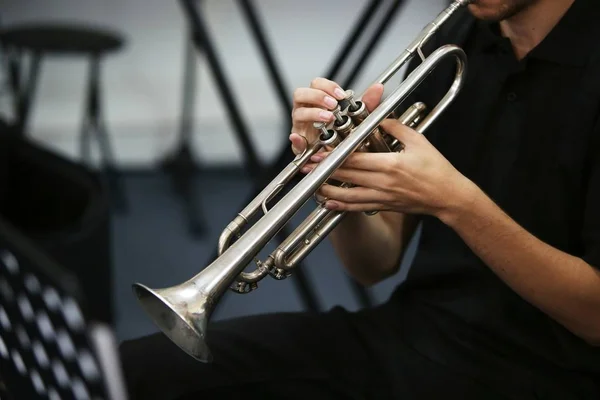 Selective focus shot of a person playing the trumpet