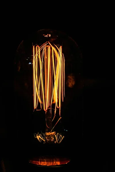 A vertical shot of orange lights dancing in the dark