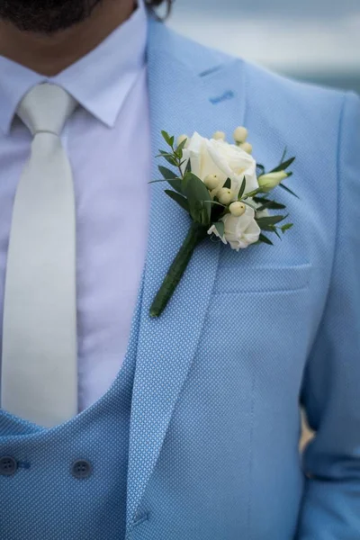 Крупним планом знімок у наречених світло-блакитний костюм і маленька біла квітка на ньому — стокове фото