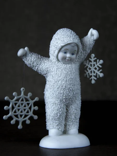 Colpo Verticale Una Statuetta Carina Bambino Che Tiene Fiocchi Neve — Foto Stock