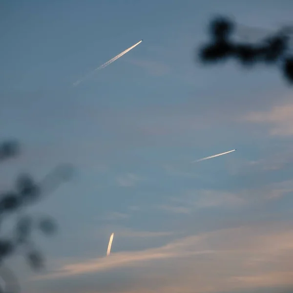 Uma Visão Baixo Ângulo Aviões Deixando Pistas Céu Durante Pôr — Fotografia de Stock