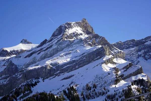 Kışın masmavi gökyüzünün altında karla kaplı dağlar. — Stok fotoğraf