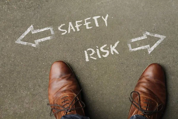 Hohe Winkelaufnahme von Sicherheit und Risiko mit entgegengesetzten Richtungen auf dem Boden — Stockfoto