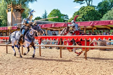 WARWICKSHIRE, UNITED KINGDOM - Aug 23, 2019: Knights Jousting in Warwick Castle, for the 'War of the Roses' enactment clipart