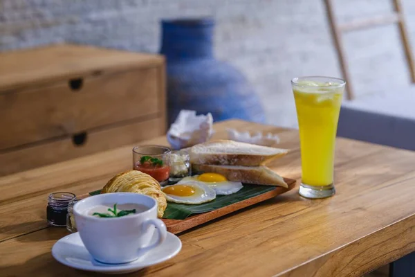 Una Bandeja Desayuno Junto Vaso Jugo Sobre Una Mesa Madera — Foto de Stock
