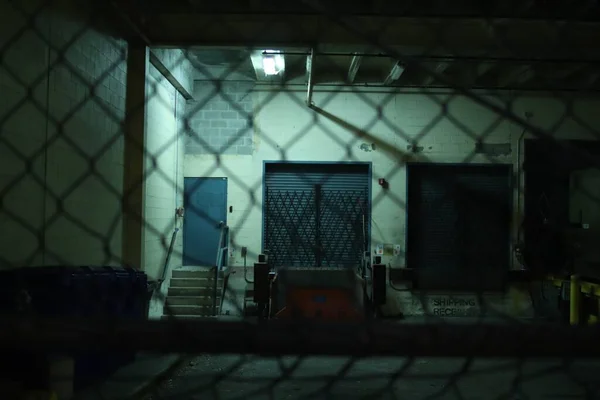 Doors through the metal fence at night — Stock Photo, Image