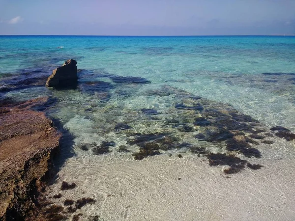Όμορφη φωτογραφία της επιφάνειας του νερού και βράχο κοντά σε μια παραλία στη Formentera, Ισπανία — Φωτογραφία Αρχείου