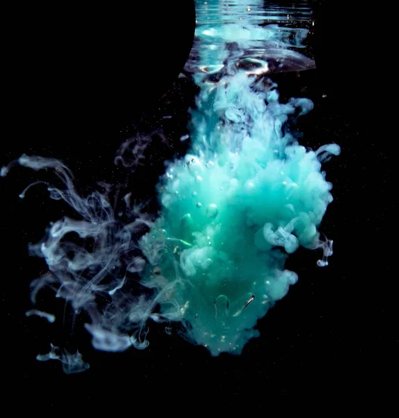 Abstract concept of teal color ink drop plume in water on an isolated  black background — Stock Photo, Image