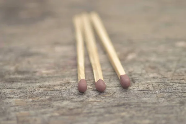 Selective focus closeup shot of three match sticks on a surface — Stock Photo, Image