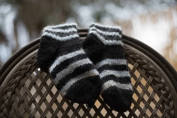 Closeup shot of striped socks hanged on the back of a chair — Stock Photo, Image