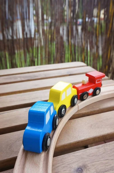 Closeup shot of colorful wooden toy blocks on wooden track — Stock Photo, Image