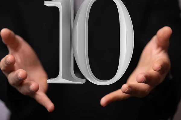 Pessoa apresentando uma projeção visual de um número digital dez em uma reunião — Fotografia de Stock