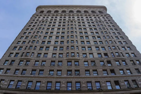 Low angle shot of a tall building under a blue sky Royalty Free Stock Images