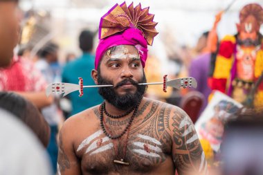 SINGAPORE, SINGAPORE - Feb 08, 2020: Thaipusam is a religious celebration by devotees. Its highlight is a barefoot walk of devotees carrying milk pots and dancing with prickly kavadis. clipart
