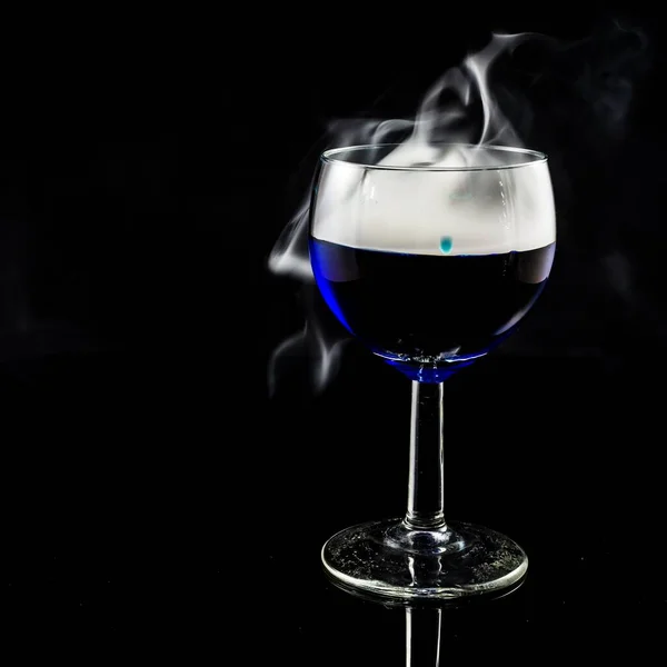 Closeup Shot Glass Filled Blue Liquid While Smoking — Stock Photo, Image